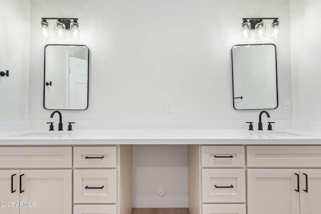 full bath featuring vanity and baseboards