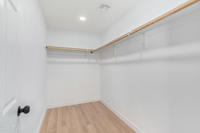 walk in closet with wood finished floors and visible vents