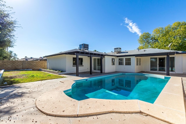 rear view of house featuring a fenced in pool, central AC, a patio, and fence