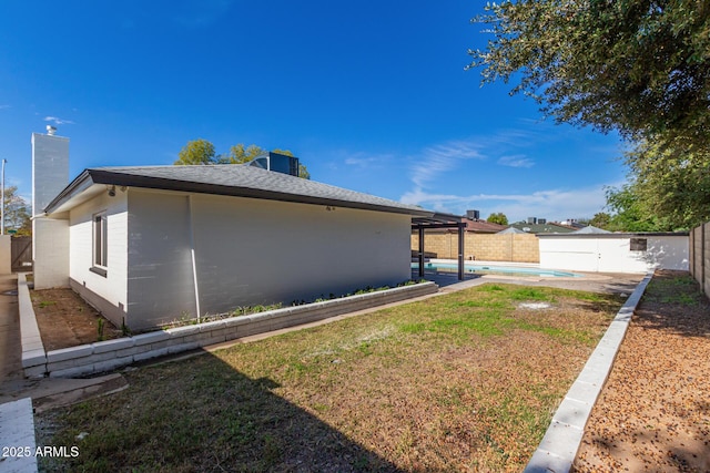 view of side of property featuring a fenced backyard, a chimney, and a fenced in pool