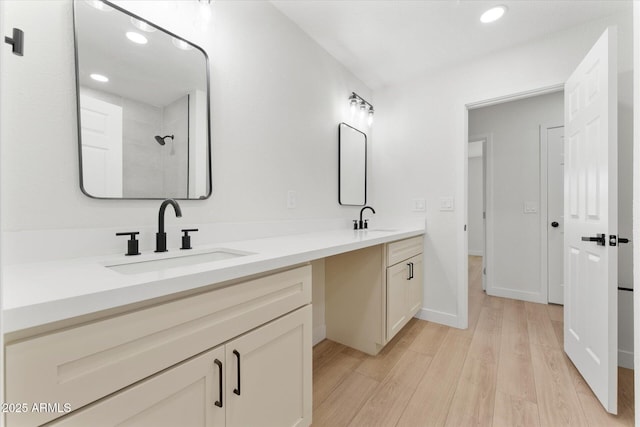 8419 N 51st Dr, Glendale, AZ 85302 - bathroom featuring double vanity, wood finished floors, baseboards, and a sink