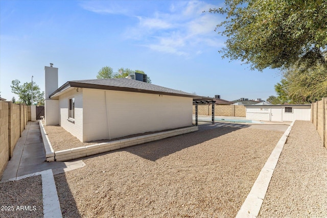 8419 N 51st Dr, Glendale, AZ 85302 - view of side of property with a fenced in pool, a patio, a fenced backyard, and a chimney