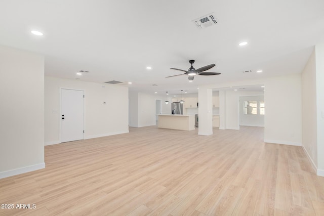 unfurnished living room featuring light wood-style floors, ceiling fan, visible vents, and recessed lighting