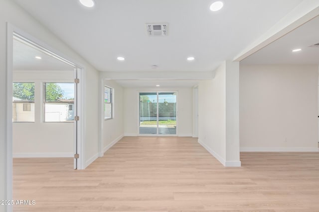 unfurnished room with light wood finished floors, baseboards, visible vents, and recessed lighting