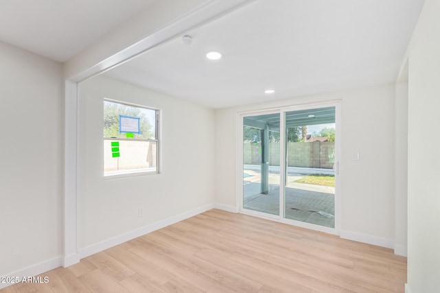 unfurnished room featuring light wood-type flooring, baseboards, and recessed lighting