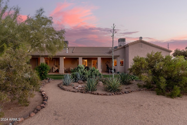 view of front of home with central air condition unit and stucco siding