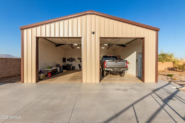 detached garage featuring fence