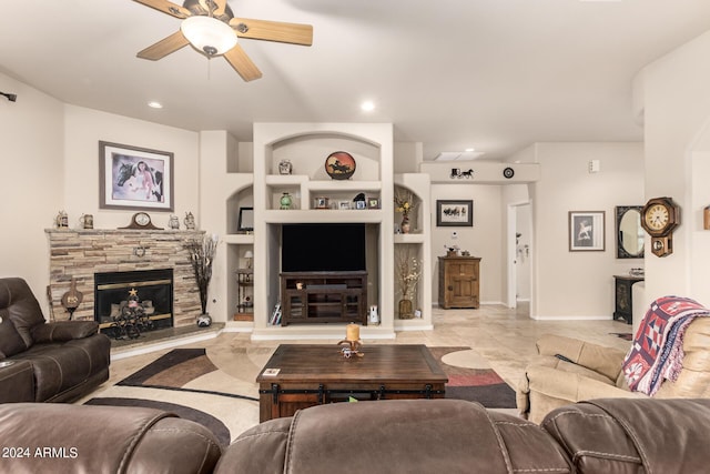 living area featuring built in shelves, a fireplace, a ceiling fan, and recessed lighting