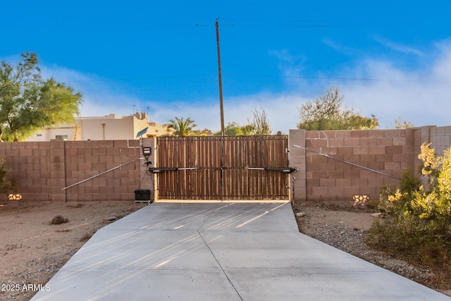 view of gate with fence