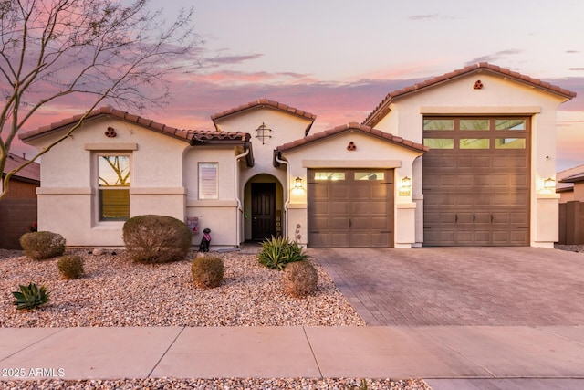 mediterranean / spanish house featuring a garage