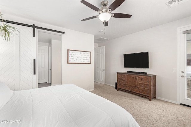 bedroom with light colored carpet, a barn door, and ceiling fan