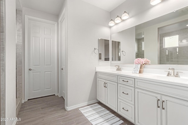 bathroom with vanity, wood-type flooring, and a shower