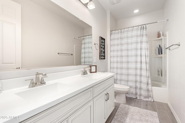 full bathroom with vanity, hardwood / wood-style flooring, toilet, and shower / bath combo with shower curtain