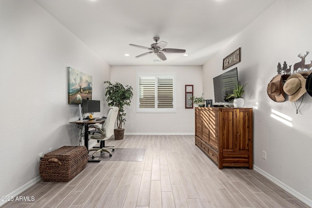 home office featuring light hardwood / wood-style floors and ceiling fan