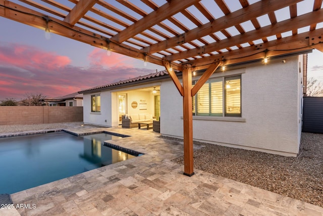 pool at dusk with an outdoor living space, a pergola, and a patio area