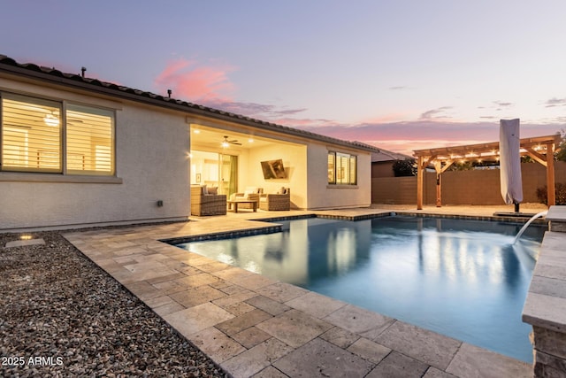 pool at dusk featuring a pergola, an outdoor hangout area, and a patio