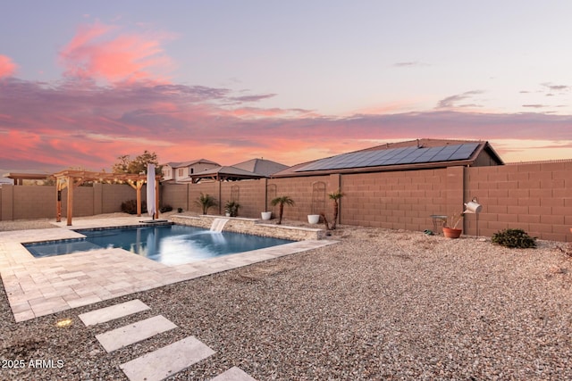 pool at dusk with a patio, a pergola, and pool water feature