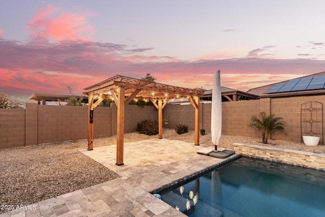 pool at dusk with a pergola and a patio area