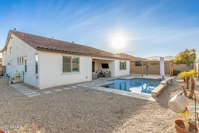 rear view of house featuring a pergola, a fenced in pool, and a patio area