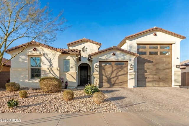 mediterranean / spanish home featuring a garage