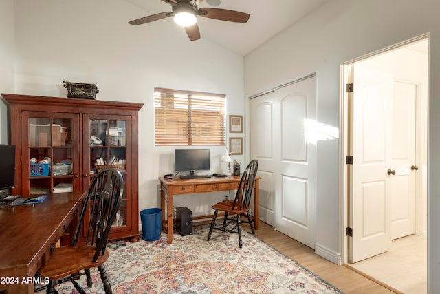 home office featuring light hardwood / wood-style floors, ceiling fan, and lofted ceiling