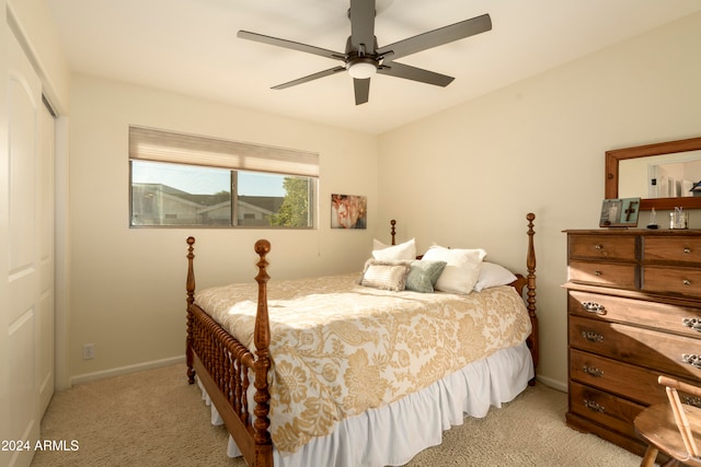 carpeted bedroom featuring ceiling fan and a closet