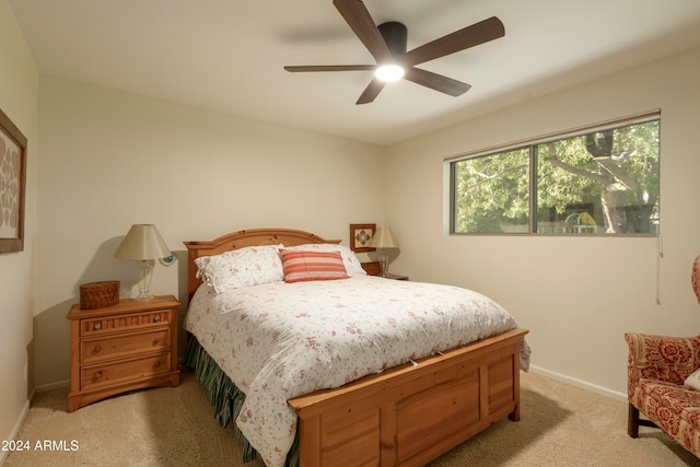 bedroom featuring light carpet and ceiling fan