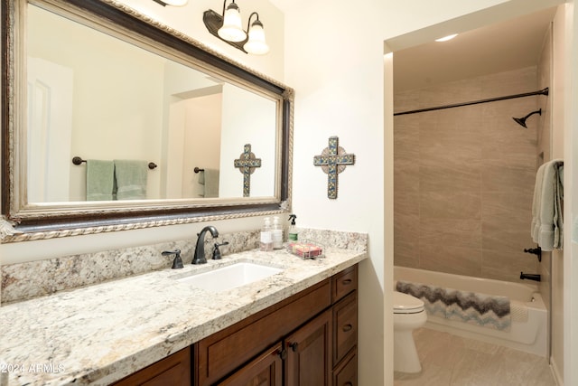 full bathroom with tile patterned flooring, vanity, tiled shower / bath combo, and toilet