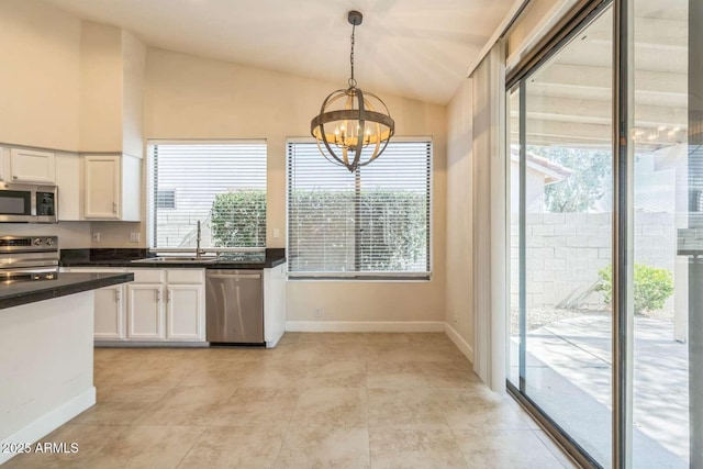 14452 N 98th Pl, Scottsdale, AZ 85260 - kitchen with appliances with stainless steel finishes, lofted ceiling, a chandelier, white cabinets, and dark countertops