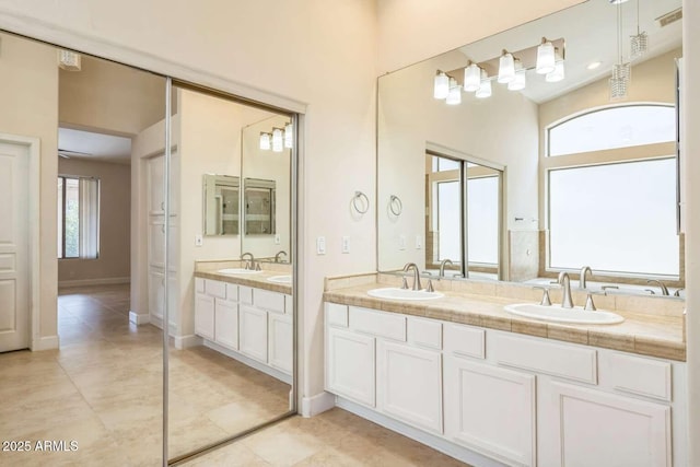 14452 N 98th Pl, Scottsdale, AZ 85260 - bathroom featuring tile patterned flooring, double vanity, and a towering ceiling