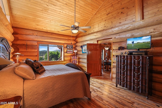 bedroom with hardwood / wood-style floors, rustic walls, high vaulted ceiling, and wood ceiling