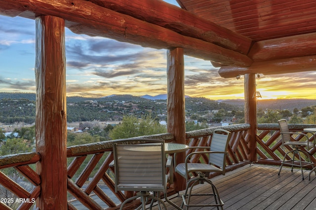 deck at dusk featuring a mountain view