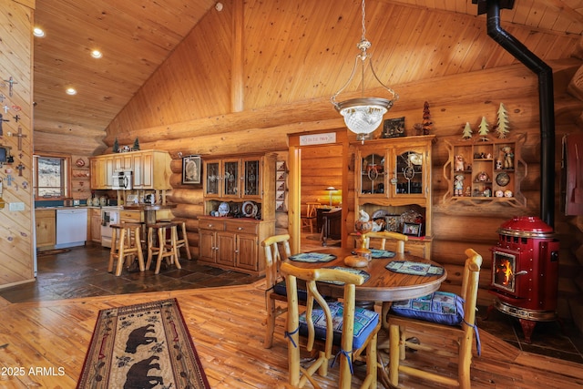 dining room with wood ceiling, wood-type flooring, high vaulted ceiling, and log walls