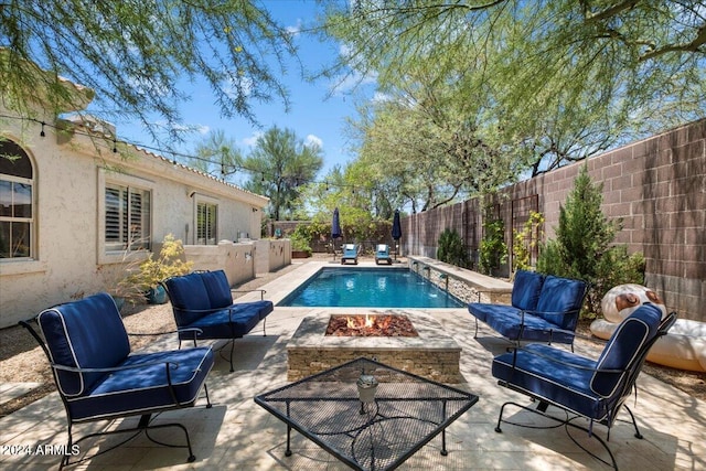 view of swimming pool featuring a fire pit and a patio area