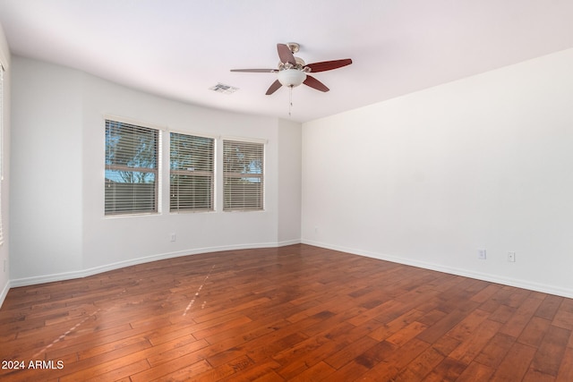 unfurnished room featuring ceiling fan and dark hardwood / wood-style flooring