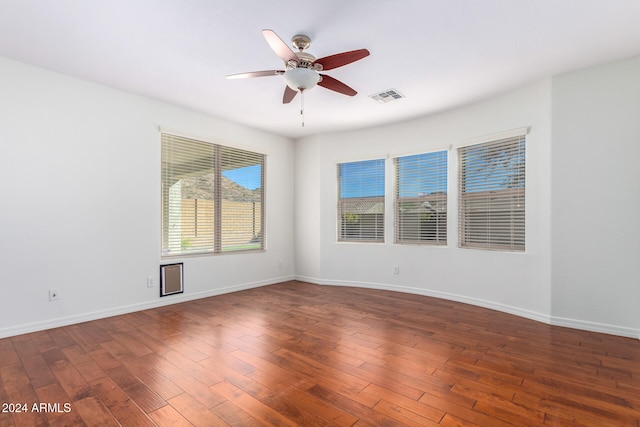 unfurnished room featuring ceiling fan and dark hardwood / wood-style flooring