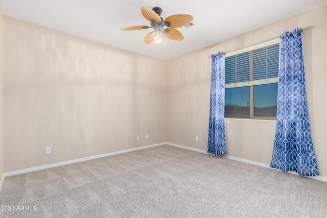 carpeted spare room with ceiling fan