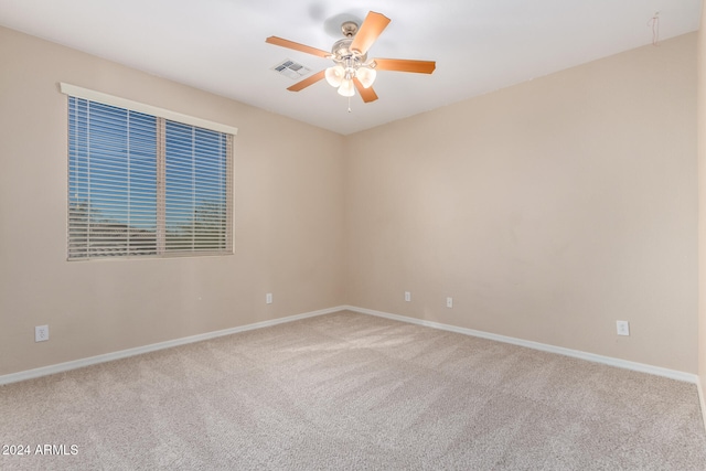 carpeted empty room featuring ceiling fan