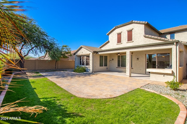 back of house with a lawn, a patio, and ceiling fan