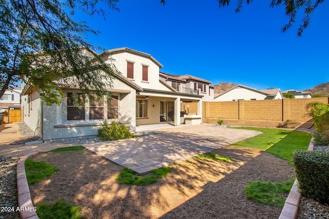 back of house with a patio area