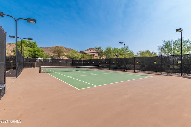 view of tennis court featuring basketball court