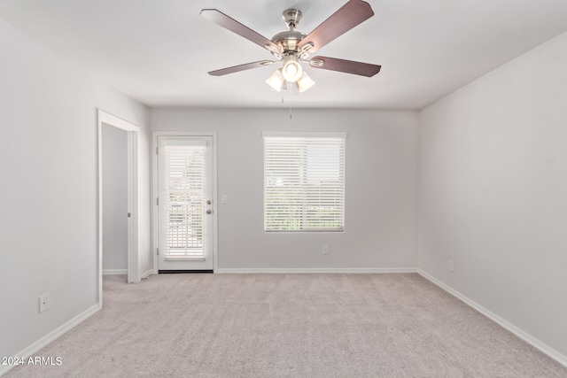 carpeted spare room with ceiling fan