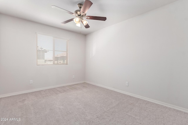 empty room with ceiling fan, baseboards, and carpet flooring