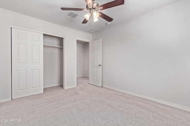 unfurnished bedroom with a closet, ceiling fan, and light colored carpet