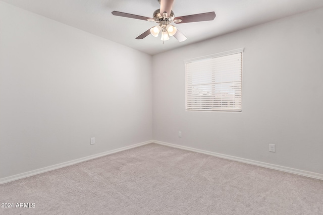 spare room with carpet floors and ceiling fan