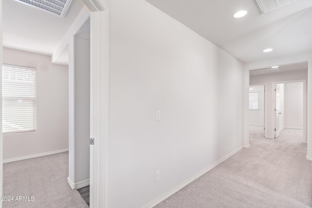 hall with carpet floors, recessed lighting, visible vents, and baseboards