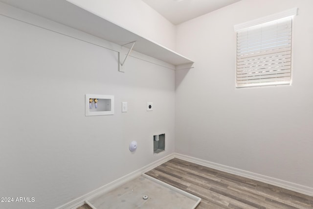 washroom featuring washer hookup, electric dryer hookup, wood finished floors, laundry area, and baseboards