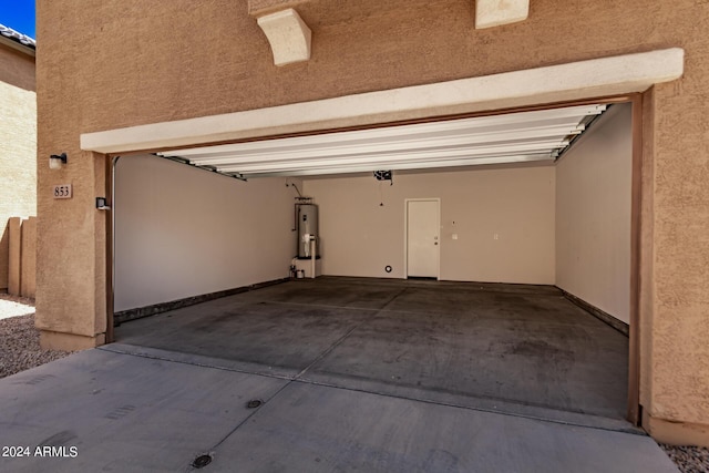 garage featuring water heater and a garage door opener