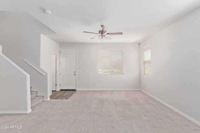 carpeted empty room featuring ceiling fan