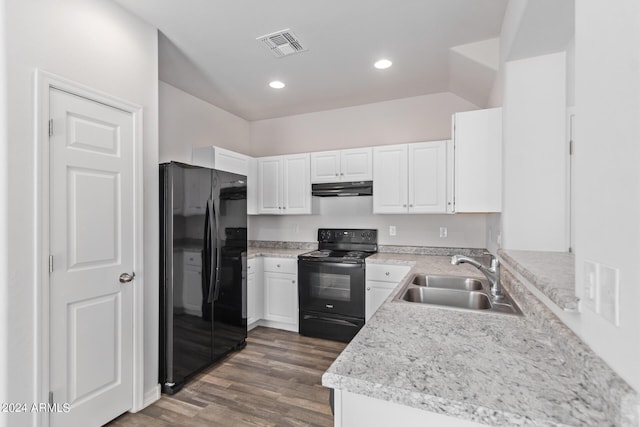 kitchen featuring visible vents, white cabinetry, a sink, under cabinet range hood, and black appliances